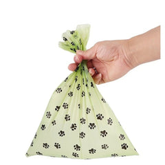 Biodegradable, scented pet waste bags with tie handles for easy and eco-friendly disposal.